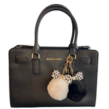 Sleutelhanger Pom Strik Strass Tas Keychain Wit samen met de zwarte variant aan een zwarte handtas