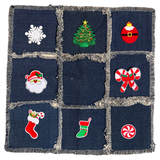 Sneeuw IJskristal Sneeuwvlok Strijk Embleem Patch samen met zeven andere kerst strijk patches op een kussenhoesje van spijkerstof